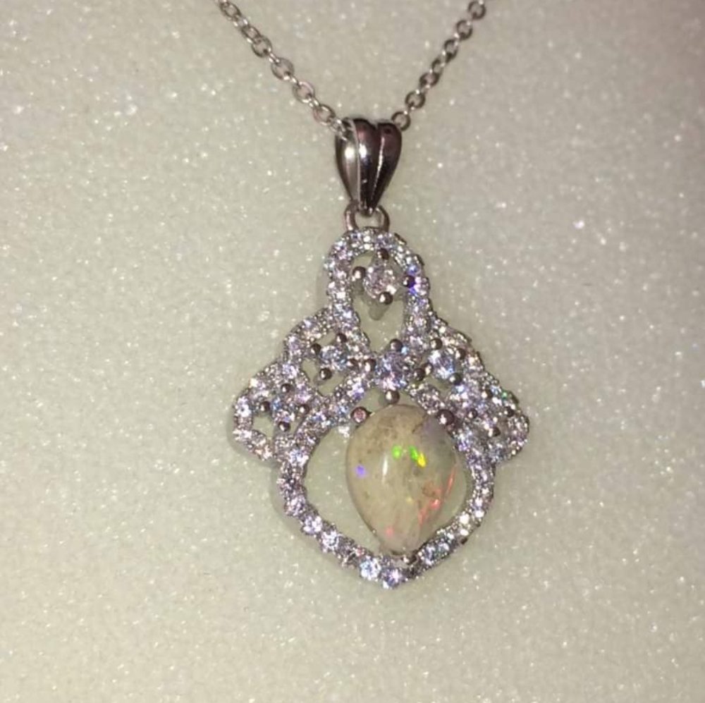 Sterling silver opalized fossil  pendant.